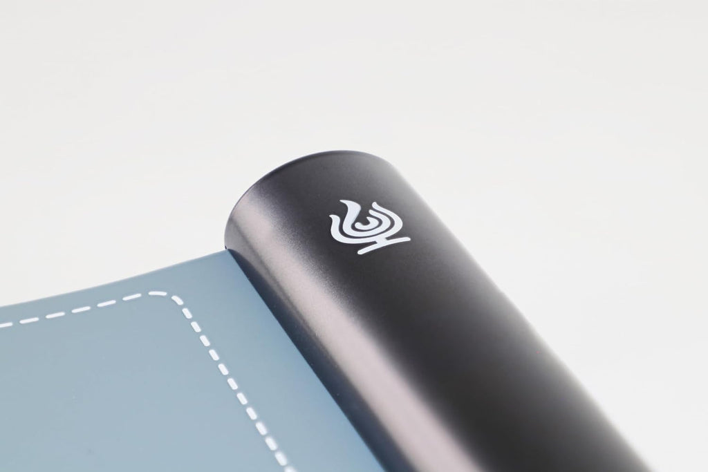 Close-up of the graphite control bar and Caterra flame emblem on the slate blue warming mat