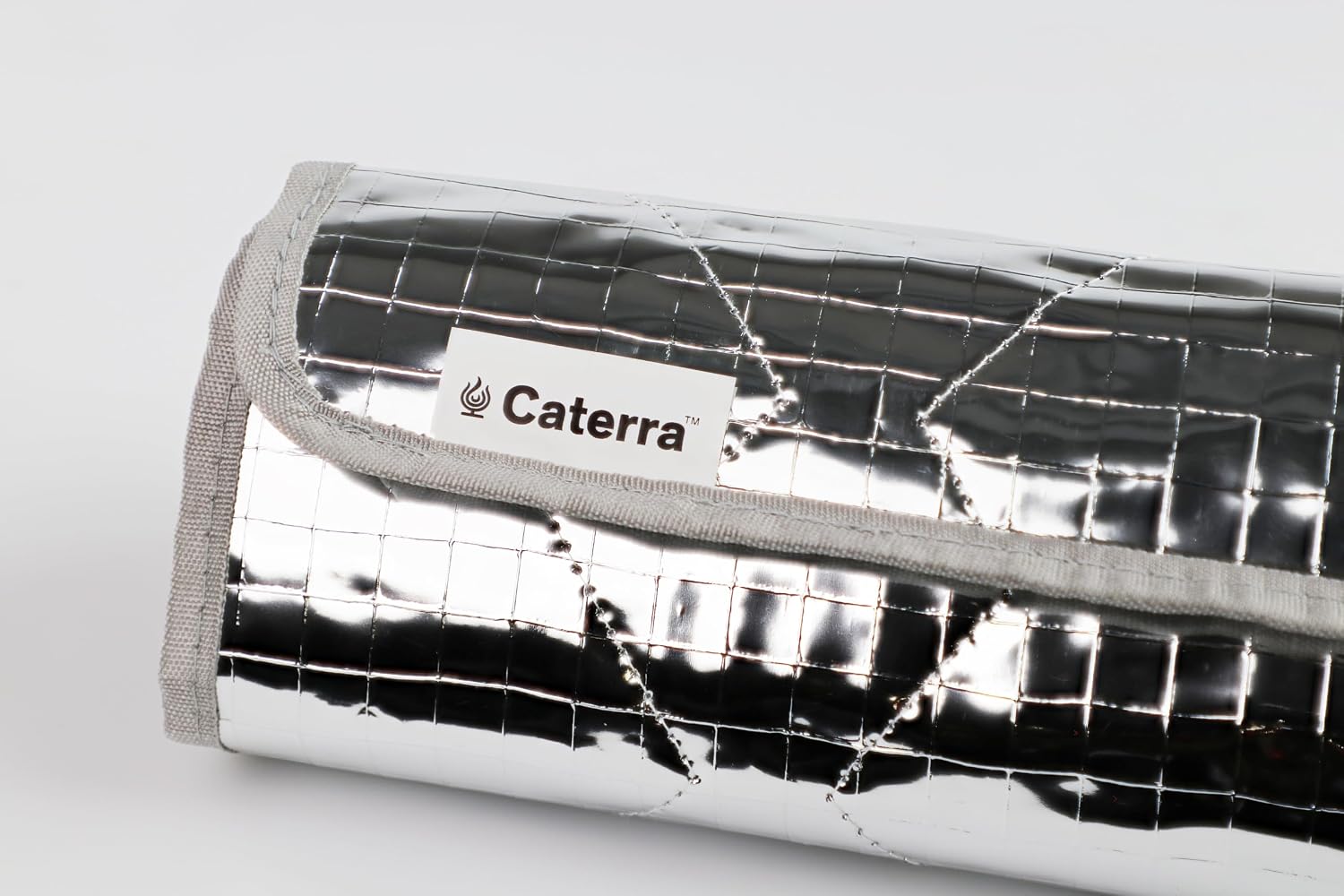 Quilted heat-reflective Caterra storage bag holding the rolled-up warming mat