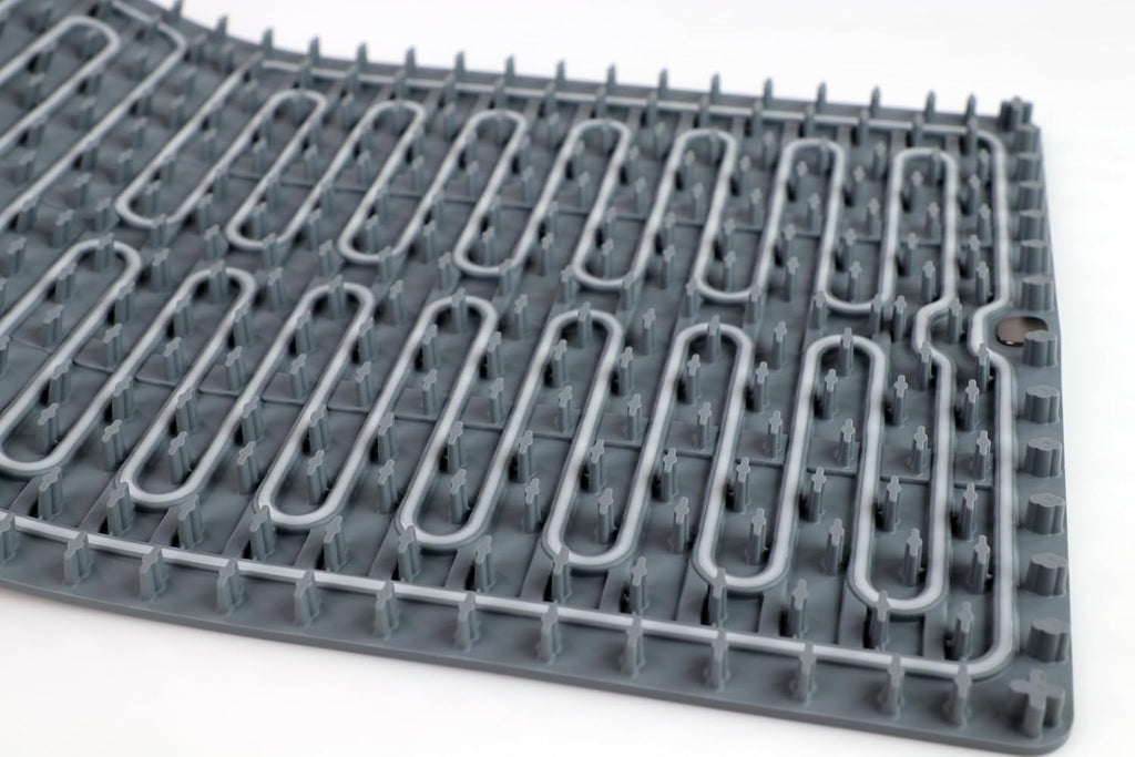 Close-up of the mat underside showing the integrated heating element and raised silicone standoffs