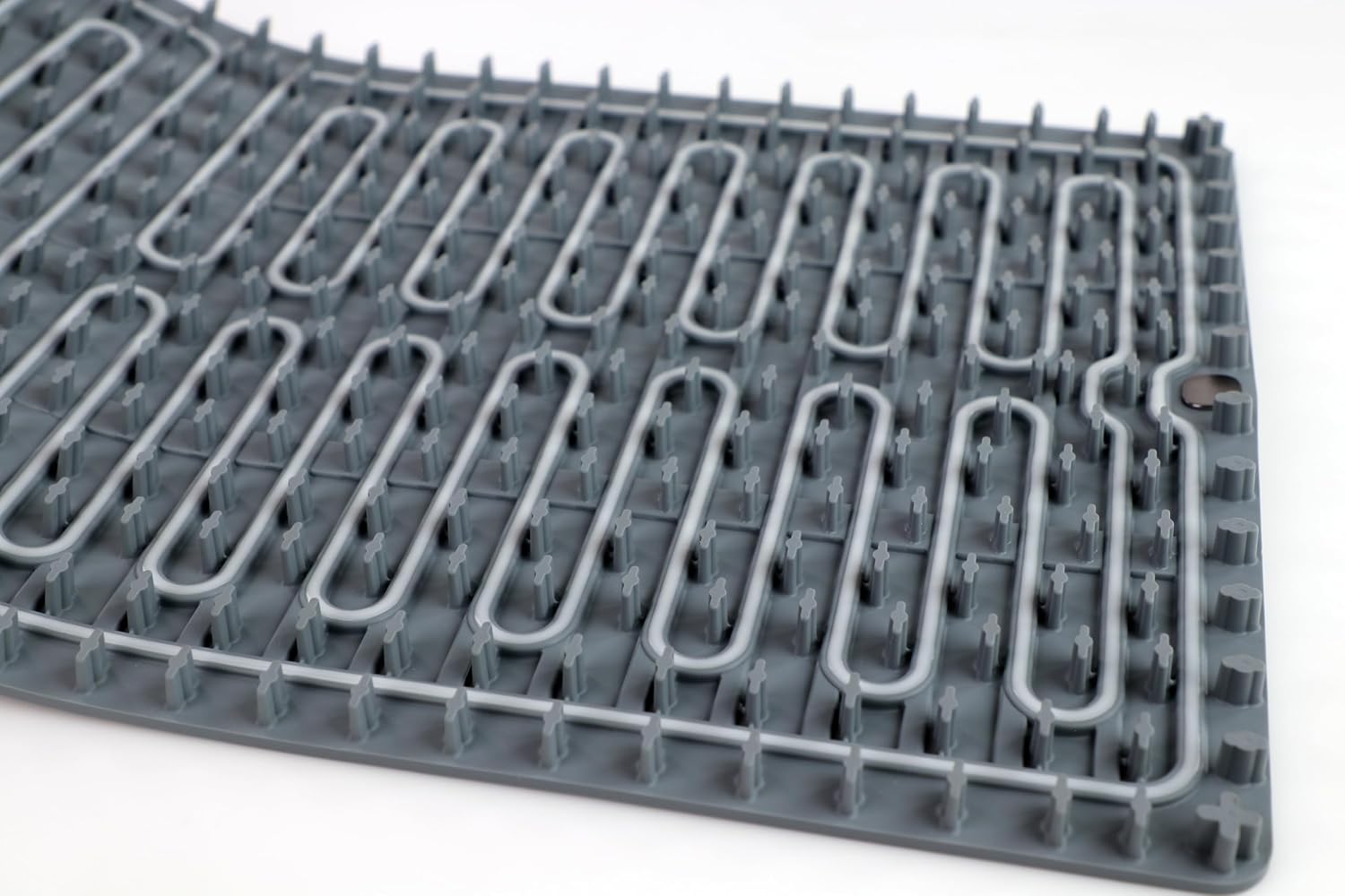 Close-up of the mat underside showing the integrated heating element and raised silicone standoffs